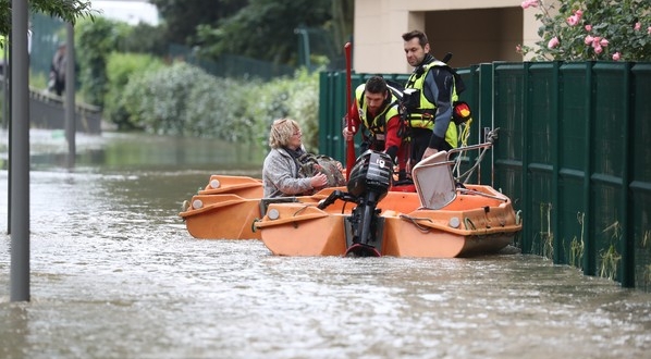 Des pompiers évacuent une femme dans une rue inondée de Longjumeau le 2 juin 2016